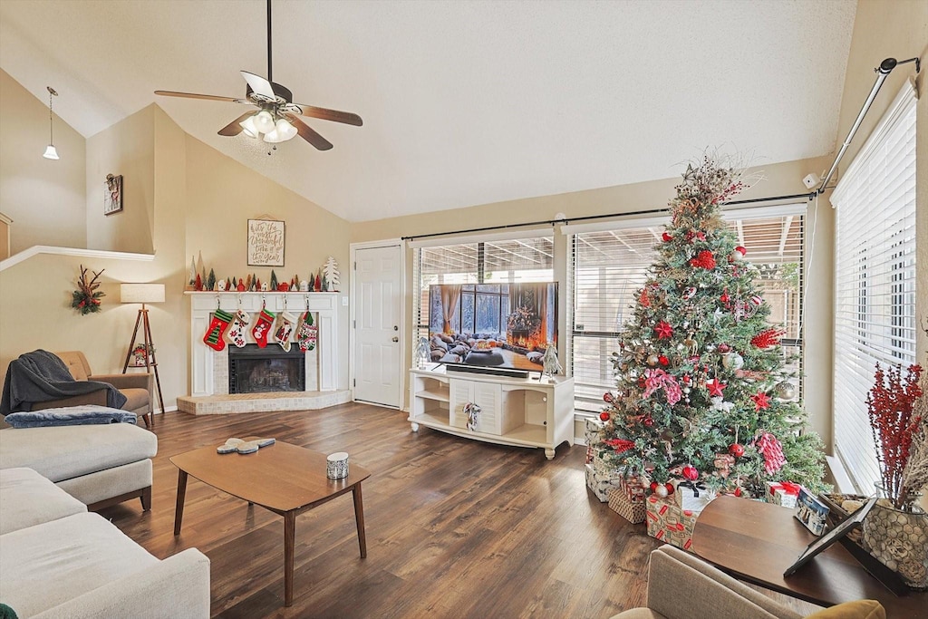 living room featuring ceiling fan, high vaulted ceiling, and dark wood-type flooring