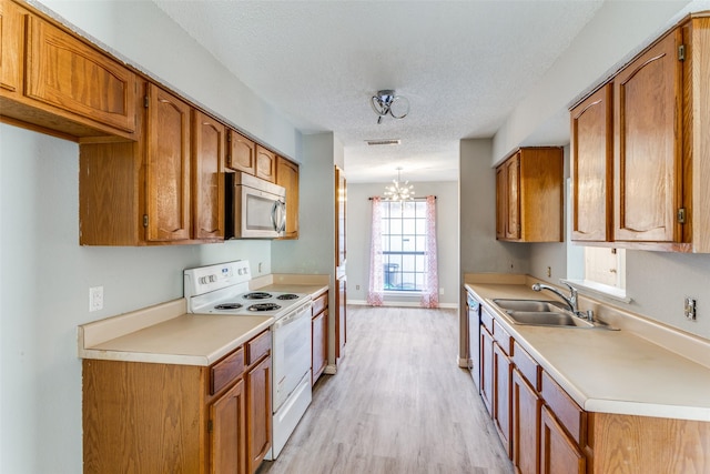 kitchen featuring sink, light hardwood / wood-style flooring, a textured ceiling, electric range, and dishwasher