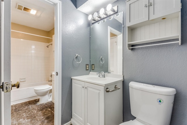 full bathroom featuring vanity, tiled shower / bath combo, and toilet