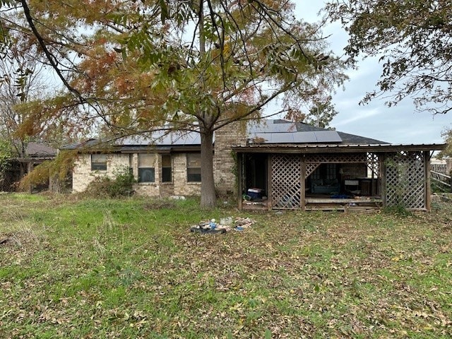 back of property featuring solar panels