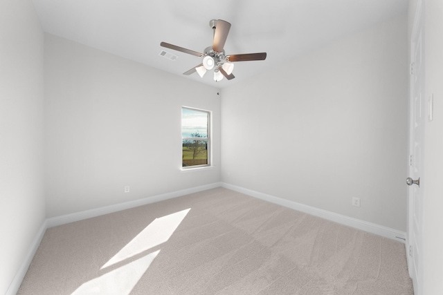 unfurnished room with ceiling fan and light colored carpet