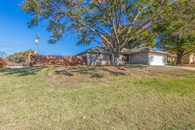 view of front of property featuring a garage and a front yard