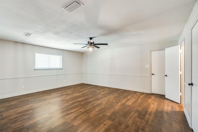 empty room with ceiling fan and dark wood-type flooring