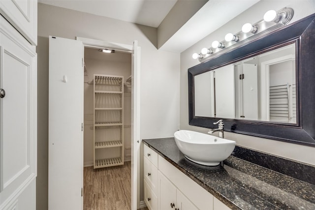 bathroom with hardwood / wood-style floors and vanity