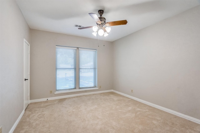 carpeted spare room featuring ceiling fan