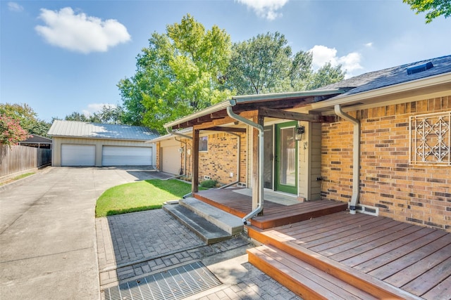 deck featuring an outbuilding and a garage