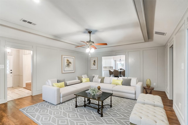 living room featuring hardwood / wood-style floors and ceiling fan