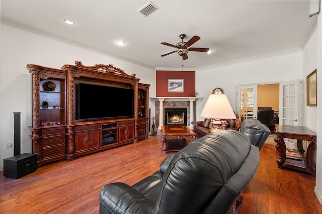 living room with french doors, hardwood / wood-style flooring, ceiling fan, and ornamental molding