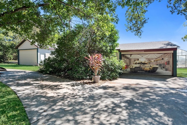 view of front of house with a garage and an outdoor structure