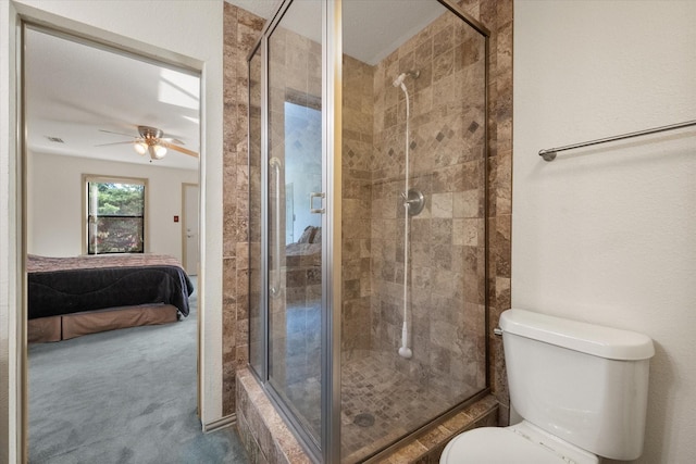 bathroom with walk in shower, ceiling fan, and toilet