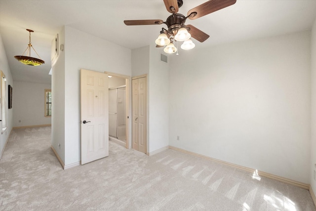 carpeted empty room featuring ceiling fan