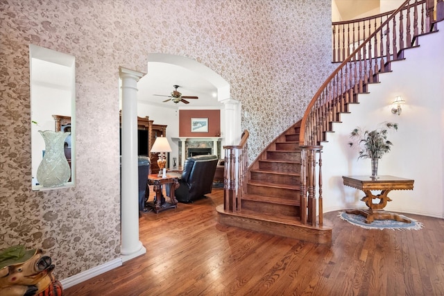 entryway with hardwood / wood-style flooring, ceiling fan, ornate columns, and crown molding