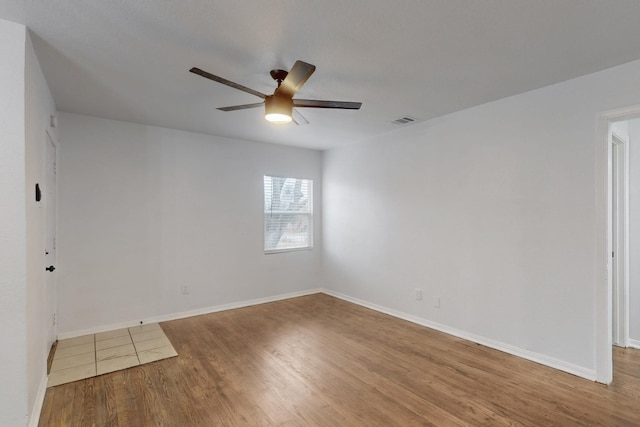 spare room featuring hardwood / wood-style flooring and ceiling fan