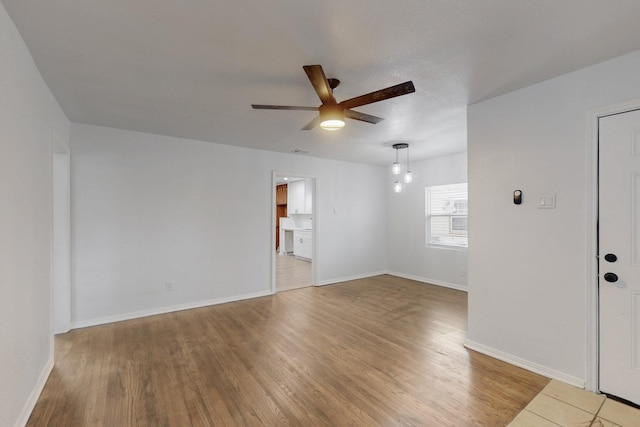 spare room with ceiling fan and hardwood / wood-style floors