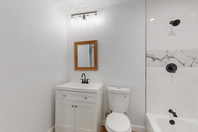 full bathroom featuring tiled shower / bath, vanity, and toilet