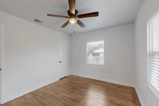 spare room with ceiling fan and hardwood / wood-style floors