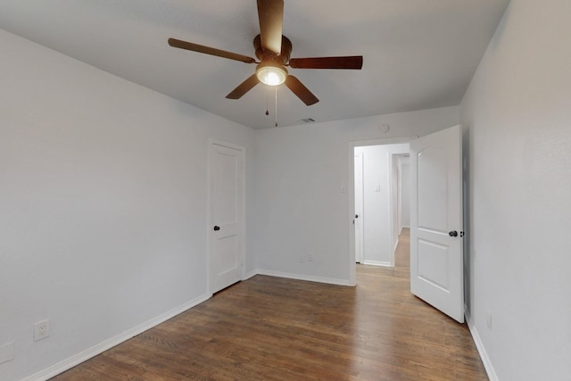 unfurnished room with ceiling fan and dark hardwood / wood-style flooring