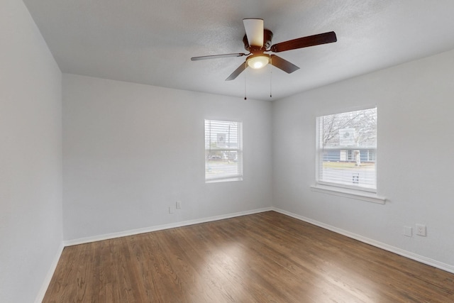 unfurnished room featuring hardwood / wood-style flooring, ceiling fan, and a textured ceiling