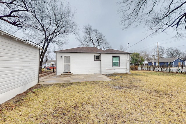 rear view of house with a patio area and a lawn