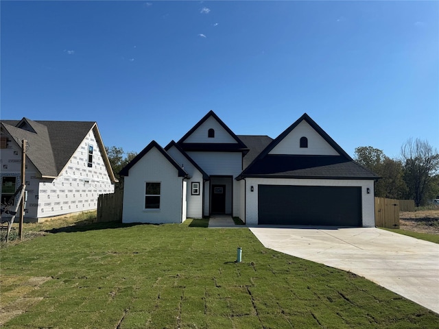 view of front facade featuring a garage and a front lawn