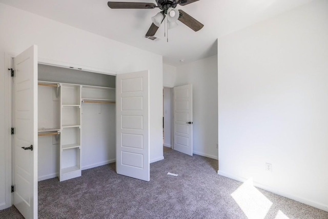 unfurnished bedroom with ceiling fan, dark carpet, and a closet