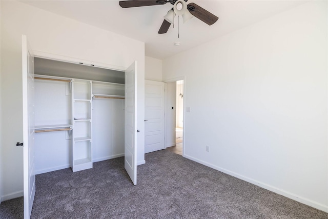 unfurnished bedroom with ceiling fan, a closet, and dark colored carpet