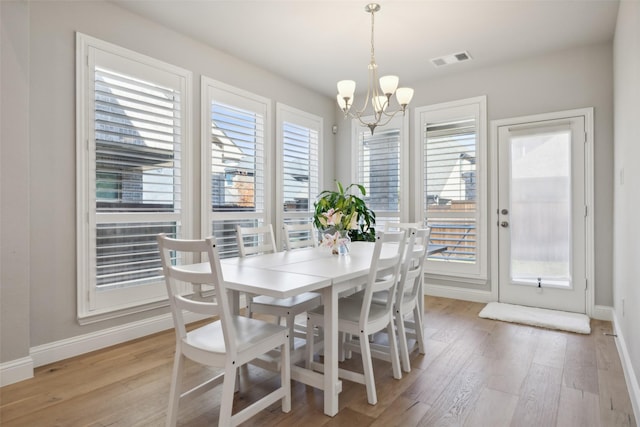 dining area featuring an inviting chandelier and light wood-type flooring