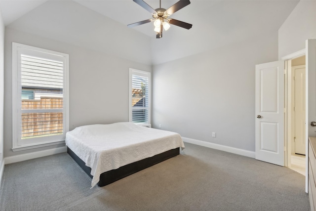 bedroom featuring ceiling fan, vaulted ceiling, and carpet