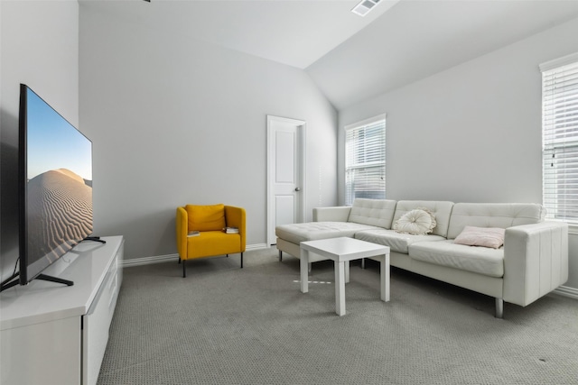 living room with vaulted ceiling and dark colored carpet