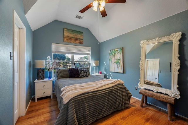 bedroom with ceiling fan, hardwood / wood-style flooring, and lofted ceiling