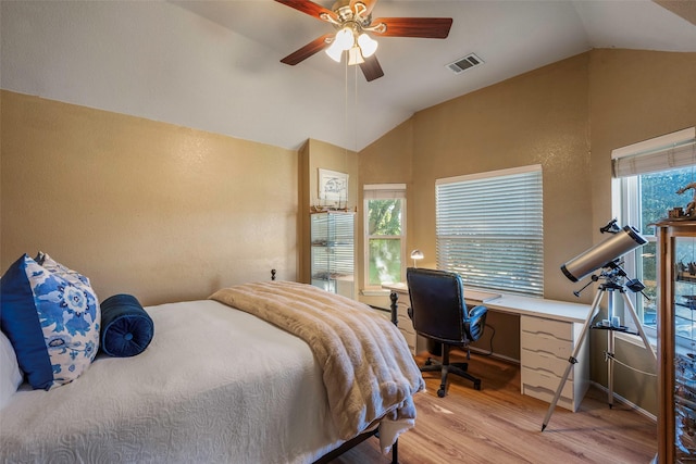 bedroom with ceiling fan, light hardwood / wood-style floors, multiple windows, and vaulted ceiling