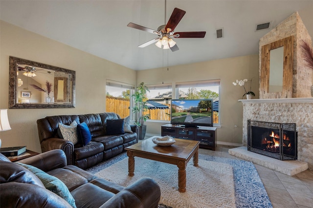 living room featuring ceiling fan, a healthy amount of sunlight, and a fireplace