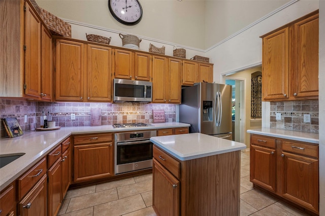 kitchen with a kitchen island, decorative backsplash, light tile patterned floors, and stainless steel appliances