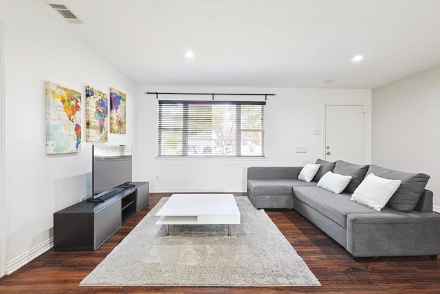 living room with dark hardwood / wood-style flooring