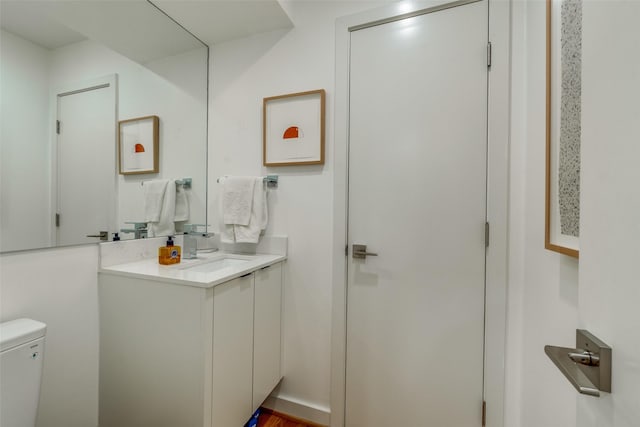 bathroom featuring vanity and toilet