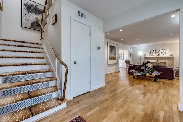 staircase featuring hardwood / wood-style floors