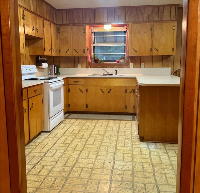 904 Uncas St, Logansport, LA 71049 - kitchen with white electric range, wooden walls, and sink