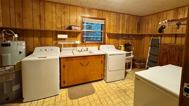 904 Uncas St, Logansport, LA 71049 - clothes washing area with wooden walls, water heater, separate washer and dryer, sink, and cabinets