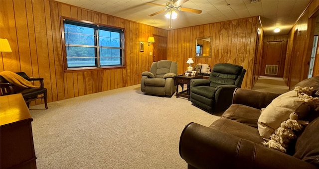 904 Uncas St, Logansport, LA 71049 - carpeted living room featuring ceiling fan and wood walls
