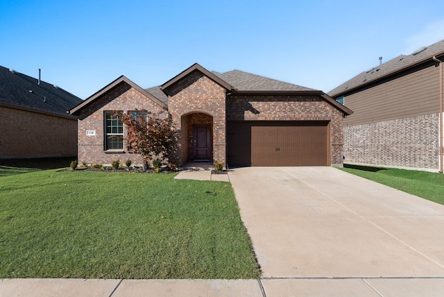 view of front of house featuring a front yard and a garage