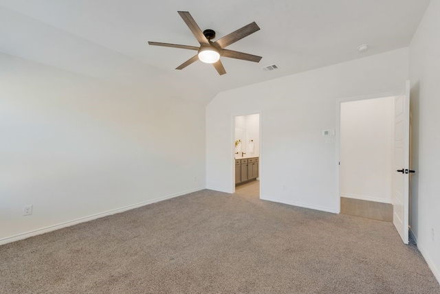 unfurnished bedroom featuring light carpet, lofted ceiling, ceiling fan, and ensuite bathroom