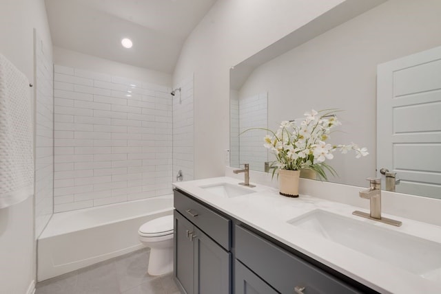 full bathroom featuring vanity, toilet, tiled shower / bath combo, and tile patterned flooring