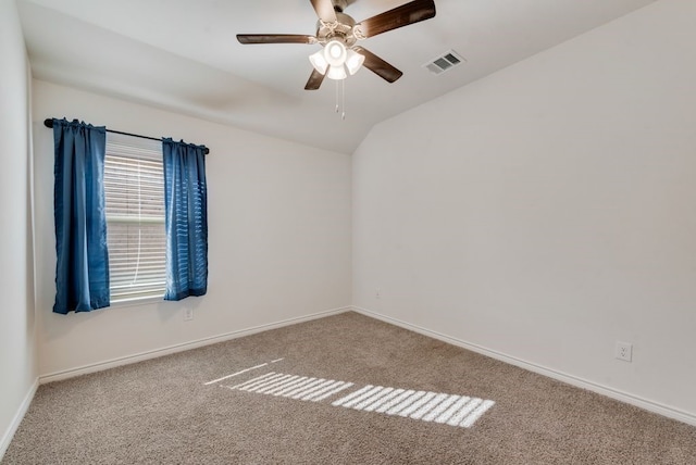 carpeted empty room featuring ceiling fan and vaulted ceiling