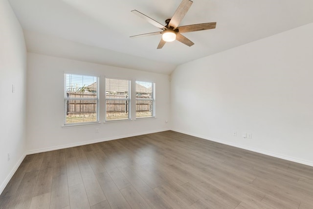 unfurnished room featuring lofted ceiling, ceiling fan, and wood-type flooring