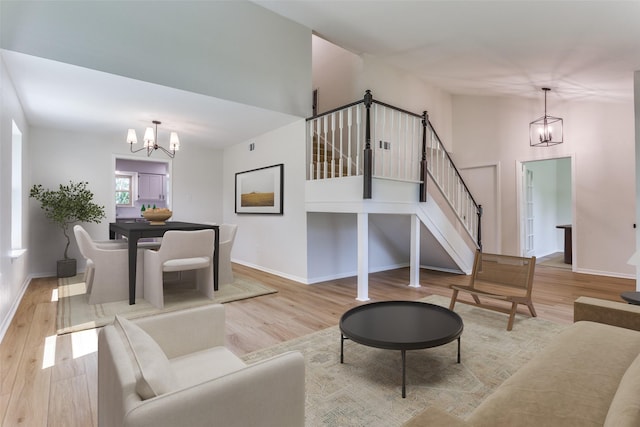 living room featuring light hardwood / wood-style floors and a chandelier