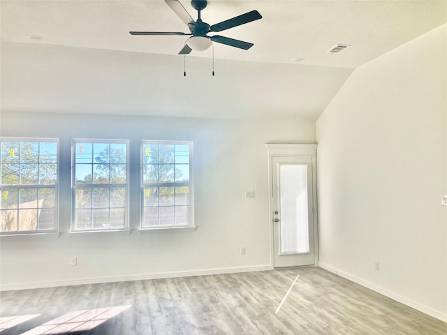 empty room with light hardwood / wood-style flooring, vaulted ceiling, and ceiling fan