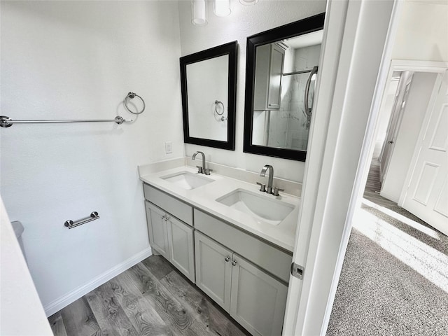 bathroom featuring hardwood / wood-style floors, vanity, and a shower with shower door