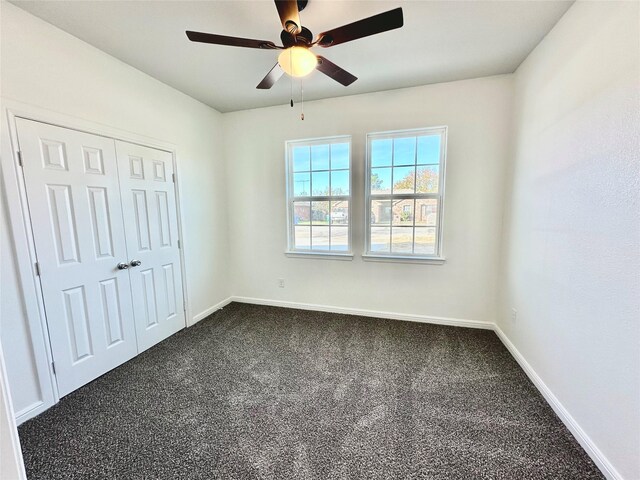 unfurnished bedroom featuring ceiling fan, carpet floors, and a closet