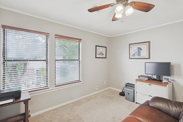 carpeted home office featuring crown molding and ceiling fan