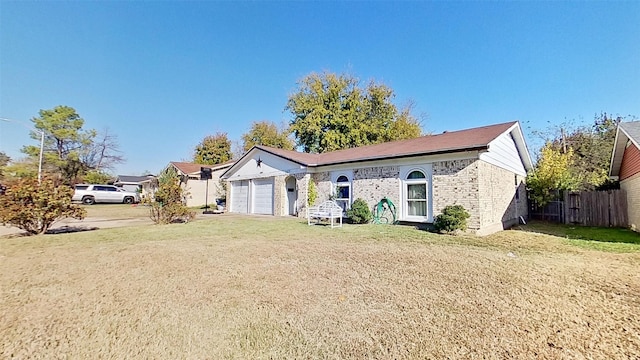 ranch-style house with a garage and a front lawn